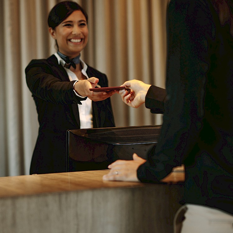 woman hotel clerk giving out a key